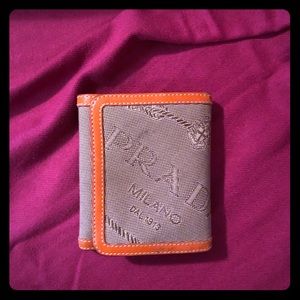 Authentic Prada canvas and leather tri-fold wallet